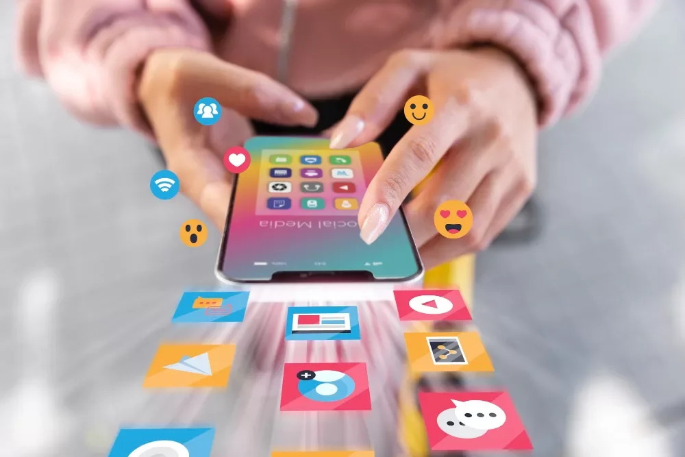 Social media management setup with laptop, phone and Canva design graphics